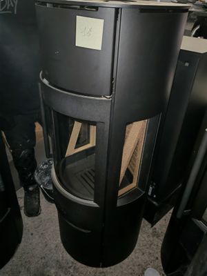a black stove sitting in the corner of a room