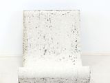 a white chair that is sitting in the corner of a room