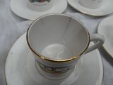 four cups and saucers sitting on a table