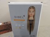 a cardboard box with a doll head on it
