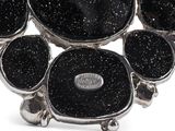 an image of a close up of a bracelet with black stones on it