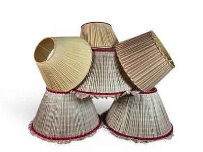 three lamps are stacked on top of each other on a white surface
