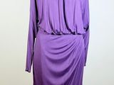 purple dress on a mannequin stand on a white background