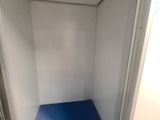a small room with a blue floor and a white wall