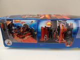 a box of playmobil with a picture of a fire station
