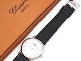 an image of a black and white watch and a brown box