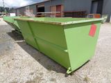 an image of a green dumpster in a yard