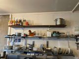a kitchen with a lot of dishes on the shelves