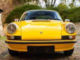a yellow sports car parked on a cobblestone street