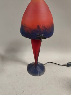 a red and blue lamp that is on a table