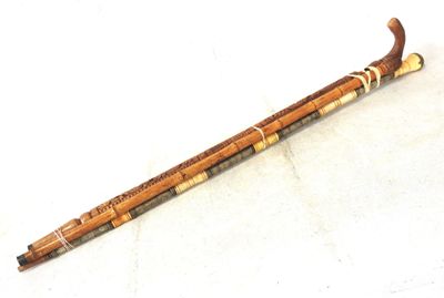 a wooden stick that is sitting on a white surface