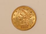 a close up of a gold coin on a white surface