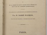 an open book on a white surface with a black border