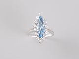 a close up of a ring with a blue topaz and white topaz