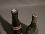 two bottles of wine sitting next to each other on a table