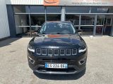 a black jeep compass parked in front of a building