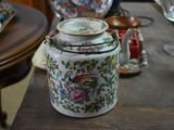 a tea pot sitting on top of a wooden table