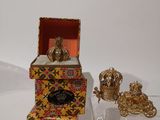 a small box that has some gold items inside of it