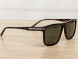 a pair of sunglasses sitting on top of a wooden table