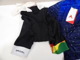two pairs of bibs and a shirt on a table