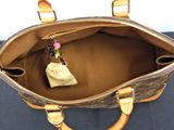 a purse with a flower in it sitting on a table
