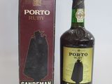 a bottle of sandeman next to a box of wine