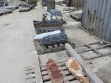 many pieces of wood sitting on a pallet in front of a building
