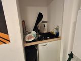 a small kitchen with a sink and a refrigerator in it