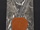 a wax seal in a plastic bag on a black surface