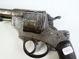 a gun with a tag on it on a white surface