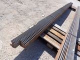 a wooden bench sitting on the ground next to a pile of pallets