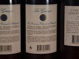 three bottles of wine sitting on top of a table next to each other