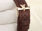 a close up of a watch with a brown strap