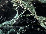 a close up of a black and white marble slab with a rose on it