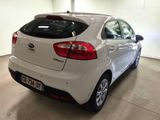 the rear end of a white car parked in a garage