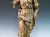bronze statue of a woman holding a bird in her hand