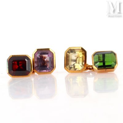 three different colored gems are displayed in a row on a white surface
