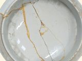 a white marble bowl with a crack in it