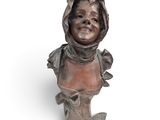 bronze bust of a woman with a hood on her head and a hood on her head
