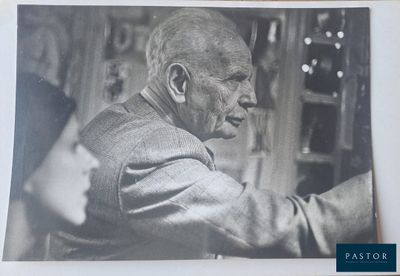 a black and white photo of an old man in a suit