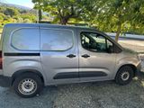 a silver van that is parked on the side of the road