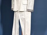 a white suit on a mannequin stand on a blue background
