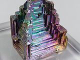 a very colorful piece of crystal on a clear plate