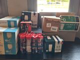 many boxes of sodas sitting on a table in front of a window