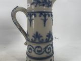 a blue and white pitcher sitting on a table