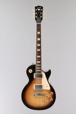 an electric guitar hanging from the ceiling in a room