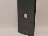 a close up of a black iphone with an apple logo on the back of it