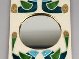 a picture of a mirror with a bird design on it