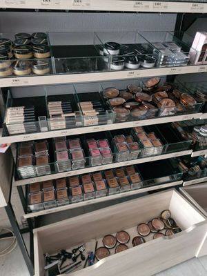 a lot of makeup products on the shelves in the store