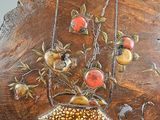 a wooden sculpture of a birdhouse with fruit on it